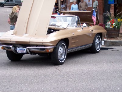 1972 Ford Ranchero - Tan 1963 Corvette Sting Ray convertible with hood open at an outdoor event.