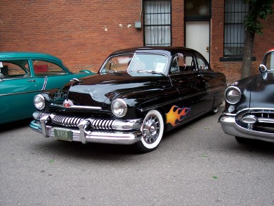 1972 Ford Ranchero - A black 1950 Mercury Eight coupe with custom flame decals is parked on a street.