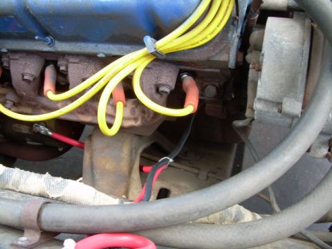 1971 Ford F-100 - Close-up view of spark plug wires and engine components, focusing on the electrical connections within the engine bay.