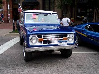 1972 Ford Ranchero - A blue 1972 Ford Bronco is parked on a street, with another blue car visible to its right.