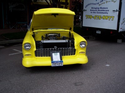 1972 Ford Ranchero - A bright yellow 1955 Chevrolet Bel Air is displayed with its hood open, revealing the engine.