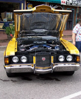 1972 Ford Ranchero - This yellow 1972 Ford Ranchero is displayed with its hood open, revealing the engine bay.