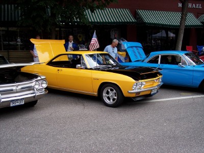 1972 Ford Ranchero - Several classic cars are displayed on a street, with people milling around them.