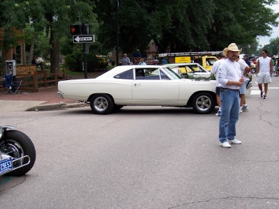 1972 Ford Ranchero - A white coupe is parked on a street with people around it.