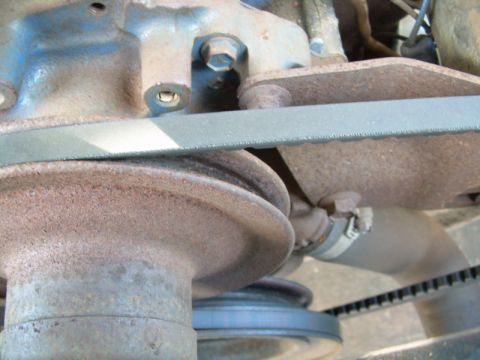 1971 Ford F-100 - Close-up view of engine belts and pulleys, showing signs of wear and rust.
