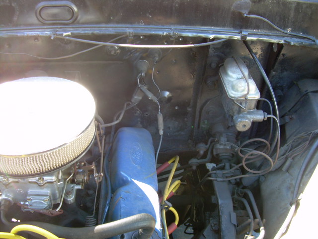 engine bay with air cleaner, carburetor, and brake fluid reservoir