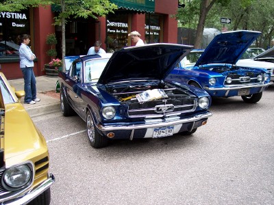 1972 Ford Ranchero - A blue 1965 Ford Mustang is displayed with its hood open, alongside other vehicles.
