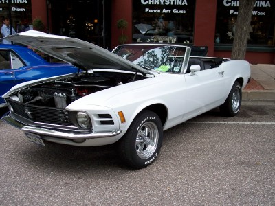 1972 Ford Ranchero - A white 1970 Ford Mustang convertible is parked with its hood open, next to a blue car.