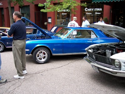 1972 Ford Ranchero - Two classic Ford Mustangs displayed on a street, one blue and one white, with hoods up.