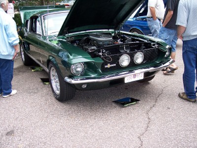 1972 Ford Ranchero - A green 1967 Ford Mustang Shelby GT500 is displayed with its hood open, revealing the engine.