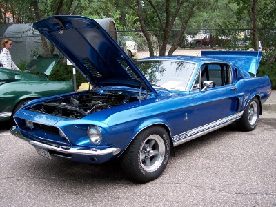 1972 Ford Ranchero - A blue 1968 Ford Mustang Shelby GT500 is displayed with its hood and trunk open, parked next to another vehicle.