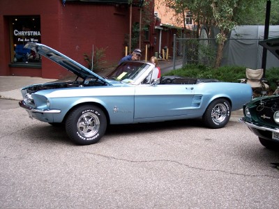 1972 Ford Ranchero - A light blue 1967 convertible is displayed with its hood open, parked alongside another vehicle.