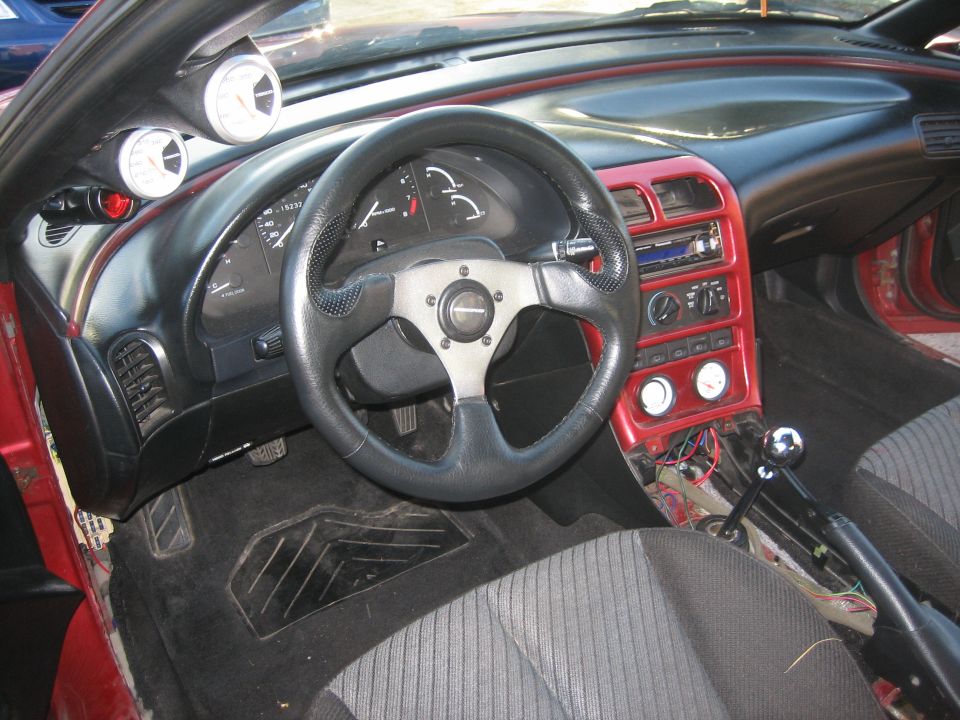 Interior of a 1993 Ford Probe showing dashboard, steering wheel, and center console