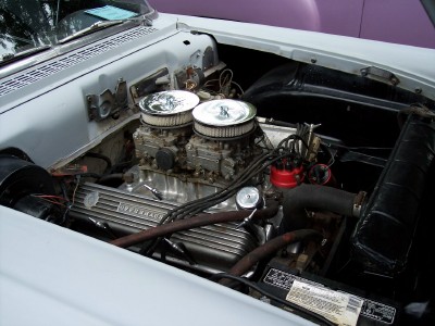 1972 Ford Ranchero - Close-up of a V8 engine bay dual carburetors and distinctive finned valve covers, suggesting a 1957 Ford model.