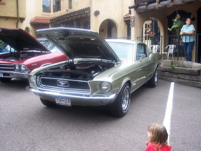 1972 Ford Ranchero - A 1967 Ford Mustang is displayed with its hood open, parked beside another vehicle.