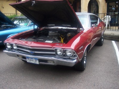 1972 Ford Ranchero - A red coupe with its hood open, revealing the engine, parked next to a blue vehicle.