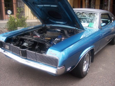 1972 Ford Ranchero - A blue 1969 Mercury Cougar is displayed with its hood open, revealing the engine and front grille.