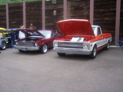1972 Ford Ranchero - Two vintage vehicles are displayed with their hoods open at an outdoor event.