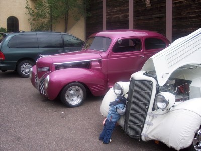 1972 Ford Ranchero - A pink sedan and a white car are parked side-by-side, both with their hoods open.