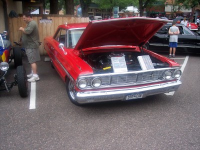 1972 Ford Ranchero - A bright red 1964 Ford Galaxie 500 is displayed with its hood open, revealing the engine bay.