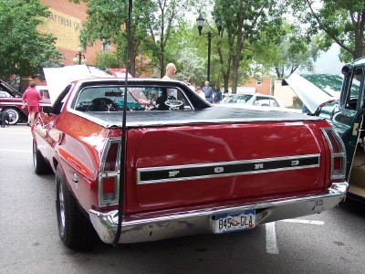 1972 Ford Ranchero - Rear view of a red 1972 Ford Ranchero pickup truck at an outdoor event with other vehicles present.
