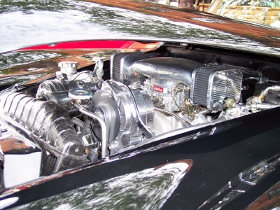 1972 Ford Ranchero - The engine bay of a classic car features a polished chrome air intake system and carburetor.