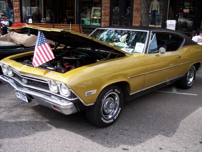 1972 Ford Ranchero - A gold 1969 Chevrolet Chevelle SS is displayed with its hood open, showing the engine and an American flag.