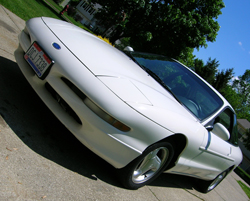 1997 Ford Probe - A white 1997 Ford Probe is parked on a driveway, viewed from the front-right angle.