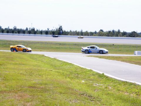 2001 Mercury Grand Marquis - Two sports cars compete on a sunny day at the Pocono Raceway.