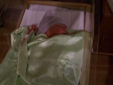 1995 Ford Bronco - Newborn baby in a hospital bassinet, with a wristband visible on its arm.