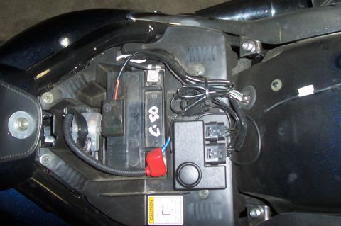 1994 Ford F-150 - Close-up of a motorcycle's battery compartment showing electrical components and wiring.