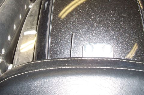 1994 Ford F-150 - A close-up view shows the textured surface of a motorcycle's fender and the stitching on its seat.