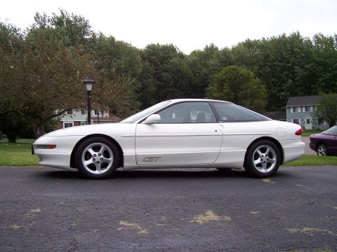 1993 Ford Probe - Side profile of a white 1993 Ford Probe GT, showing its distinctive coupe body style and GT badging.
