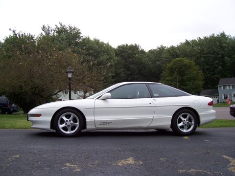 1993 Ford Probe - Side profile of a white 1993 Ford Probe GT coupe parked on a paved surface.