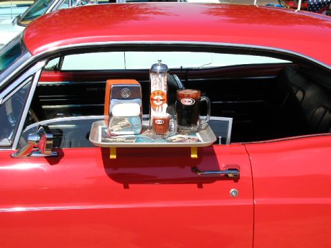 1967 Ford Ranchero - A&W root beer and condiments are served on a tray attached to the door of a vintage red car.