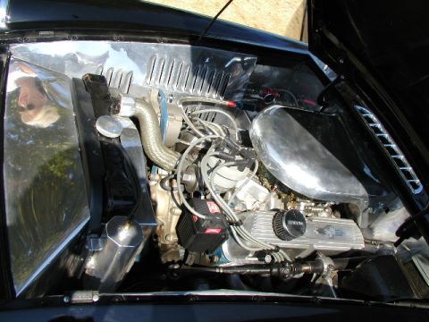 1967 Ford Ranchero - The engine bay of a classic vehicle features a V8 engine with polished chrome components and custom detailing.