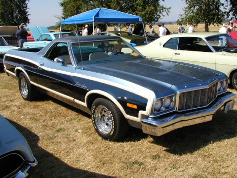 1967 Ford Ranchero - This two-tone Ford Ranchero features chrome wheels and distinctive racing stripes, parked at a car show.