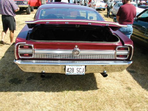 1967 Ford Ranchero - Rear view of a red 1967 Ford Ranchero at a car show with the trunk open.