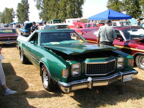 1967 Ford Ranchero - A green 1977 Ford Ranchero is displayed with its hood open at a car show.
