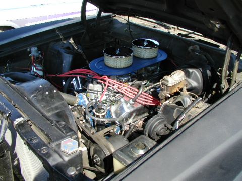 1967 Ford Ranchero - The engine bay of a 1967 Ford Ranchero features dual carburetors and a prominent blue air cleaner assembly.
