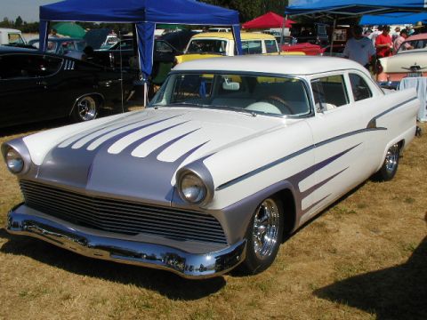 1967 Ford Ranchero - Custom 1955 Ford Fairlane Crown Victoria with flame paint job at a car show.
