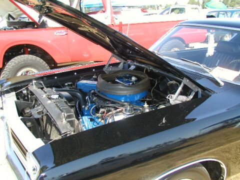 1967 Ford Ranchero - Engine bay of a 1967 Ford Ranchero, showing blue engine parts and a black air cleaner assembly.