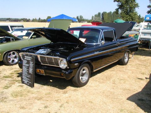 1967 Ford Ranchero - A black Ford Ranchero is displayed with its hood open at an outdoor car show.