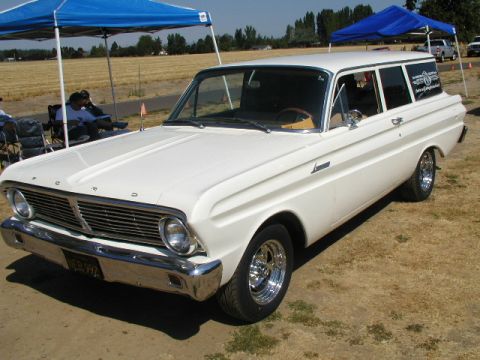 1967 Ford Ranchero - A white 1964 Ford Falcon station wagon is parked outdoors, chrome wheels and a visible license plate.