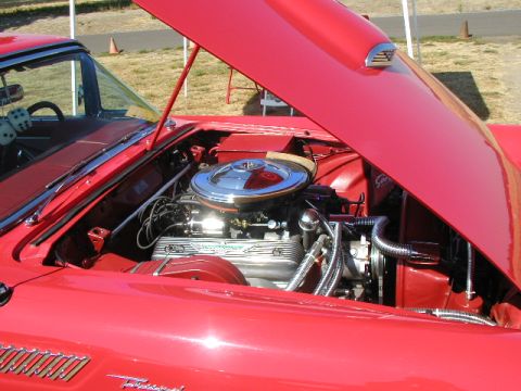 1967 Ford Ranchero - The engine bay of a red 1957 Ford Thunderbird is open for viewing.