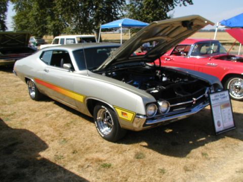 1967 Ford Ranchero - A silver 1971 Ford Torino GT is displayed with its hood open at an outdoor car show.