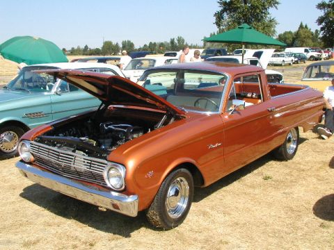 1967 Ford Ranchero - This 1967 Ford Ranchero is displayed with its hood open at a car show, revealing the engine bay.