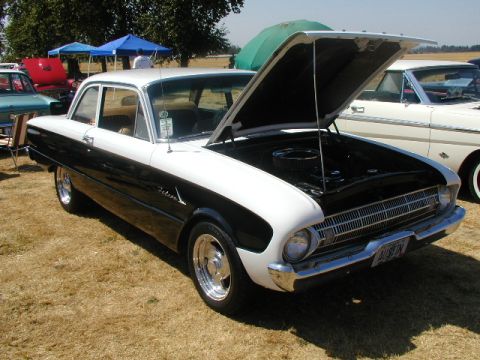 1967 Ford Ranchero - Two-tone 1960 Ford Falcon at a car show, hood up revealing the engine bay.