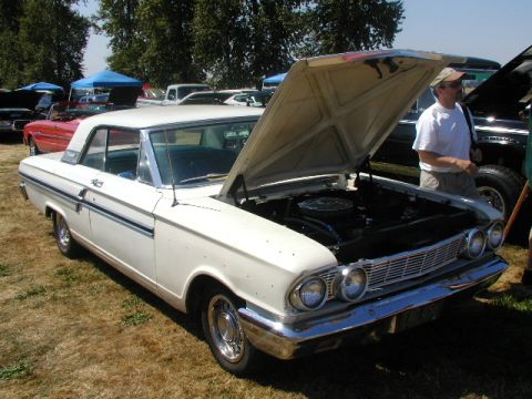 1967 Ford Ranchero - White 1962 Ford Galaxie on display at a car show, hood up revealing the engine bay.