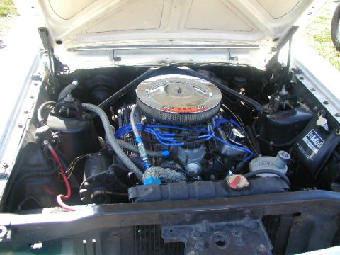 1967 Ford Ranchero - The engine compartment of a vehicle, a V8 engine with a prominent chrome air filter housing.